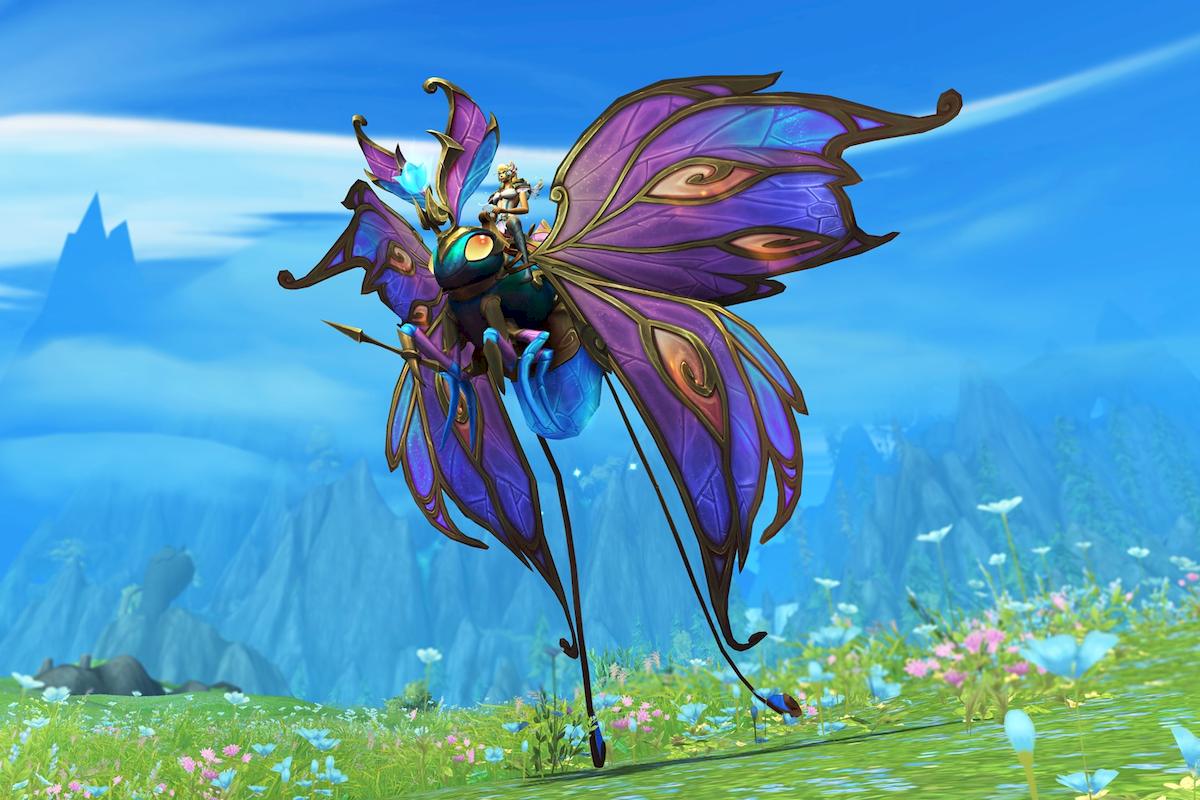 A gorgeous purple swallowtail butterfly mount, grading to blue at its wing edges with peachy wing spots and metallic brass framework (on closer inspection it appears to be mechanical and its wings resemble leadlighting). It has a blue abdomen, teal head and thorax, blue and purple antennae, and peach-coloured glassy eyes. It sports a brassy diadem with and light blue or aqua tulip-like gem. Its front right leg sports a spear of the same metal.